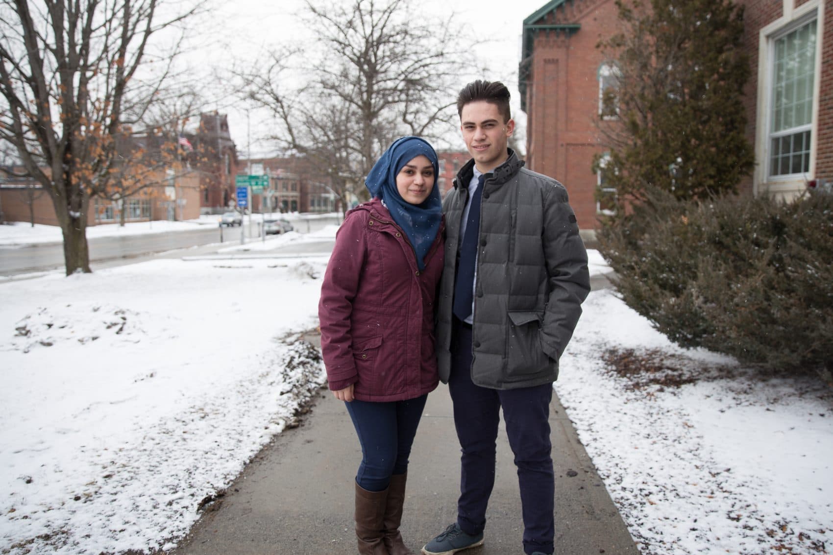 Ghena, left, and Ayman Alsalloumi stand on the St. Johnsbury campus on a snowy January day. Their family is from Homs, Syria, a city torn apart by civil war. (Ryan Caron King for NENC)