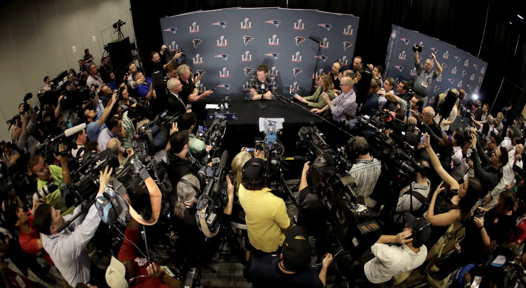 Pre-Super Bowl Houston feels like an alternate reality, writes Shira Springer. It's a land in which Tom Brady’s brand of blinders-on positivity can thrive, and the NFL brand can shine. Pictured: New England Patriots quarterback Tom Brady talks to the media during a news conference for the NFL Super Bowl 51 football game against the Atlanta Falcons. Tuesday, Jan. 31, 2017, in Houston. (Charlie Riedel/AP)