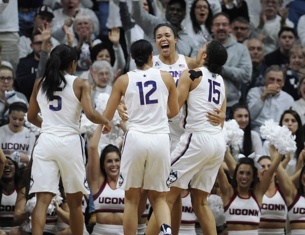 Connecticut's Napheesa Collier, center, celebrates with teammates Crystal Dangerfield, left, Saniya Chong, and Gabby Williams, right, after beating South Carolina 66-55. (Jessica Hill/AP)