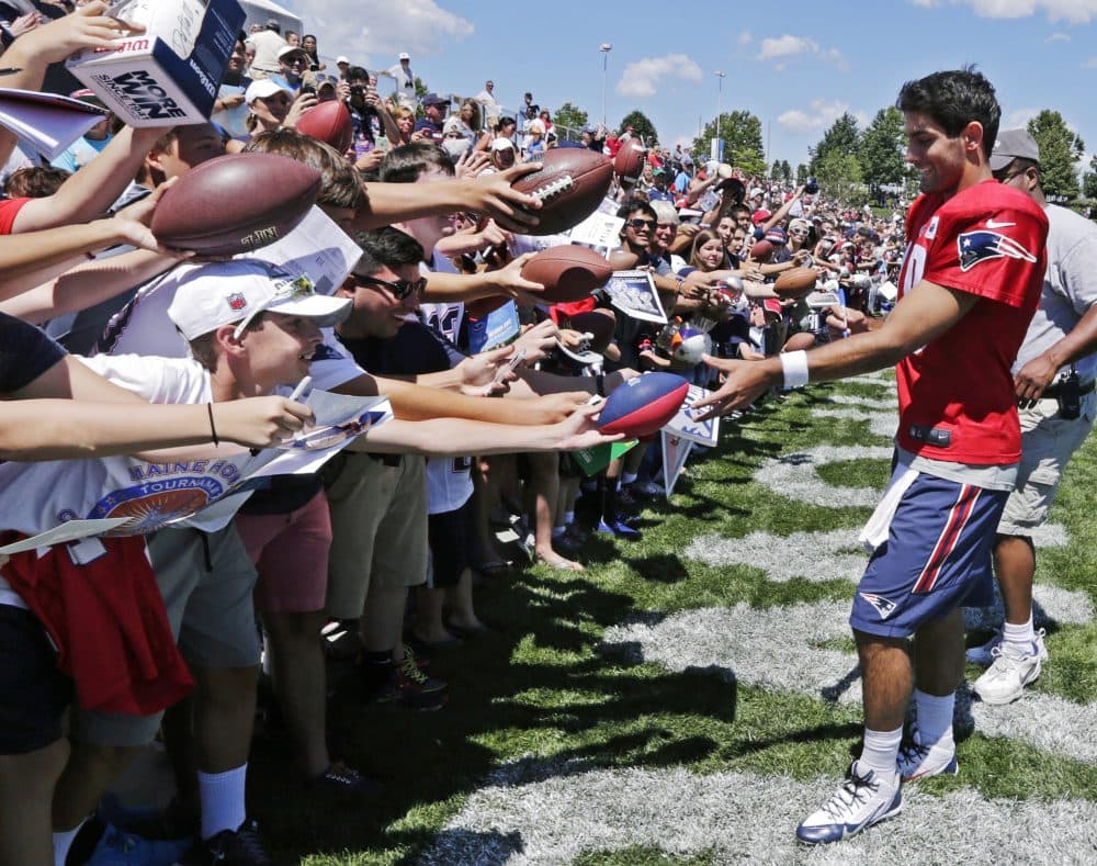 New England Patriots quarterback Jimmy Garappolo signs autographs for fans during training camp in Foxborough in 2015. (Charles Krupa/AP)