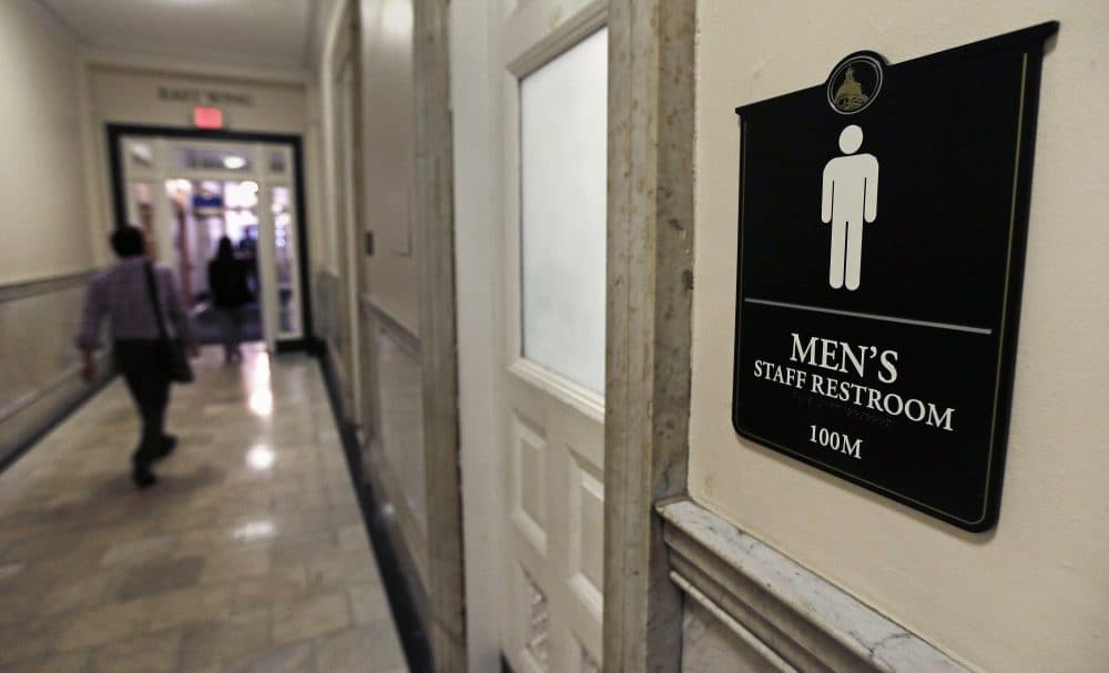A sign for a men's bathroom at the Massachusetts Statehouse in Boston. (Charles Krupa/AP)