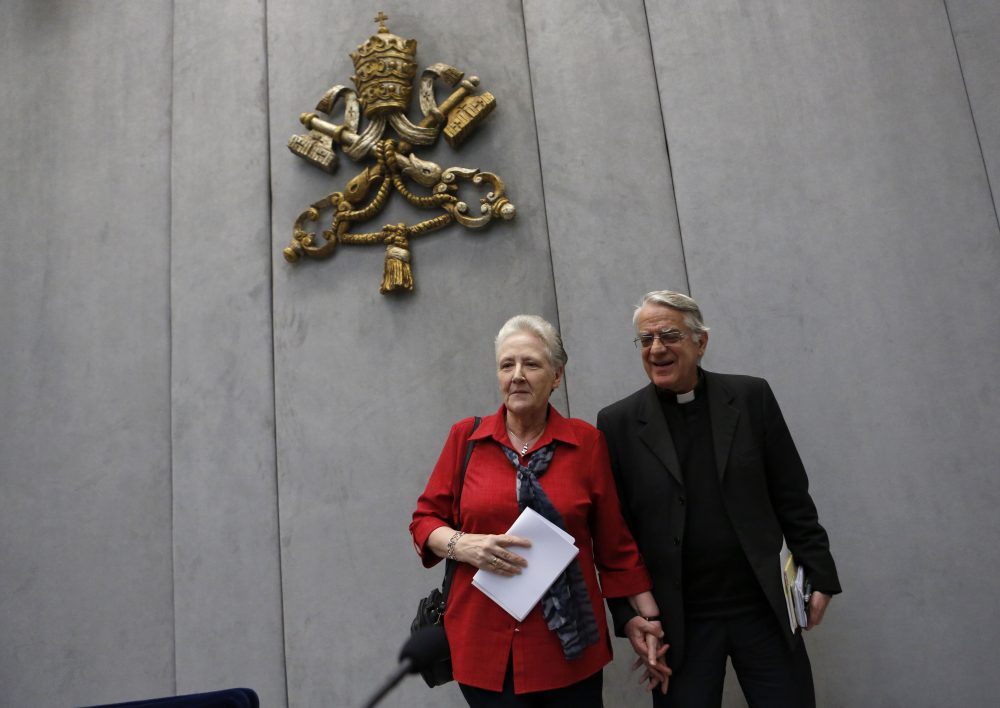 Marie Collins, left, and Vatican spokesman father Federico Lombardi leave at the end of a press conference at the Vatican in 2014. (Riccardo De Luca/AP)