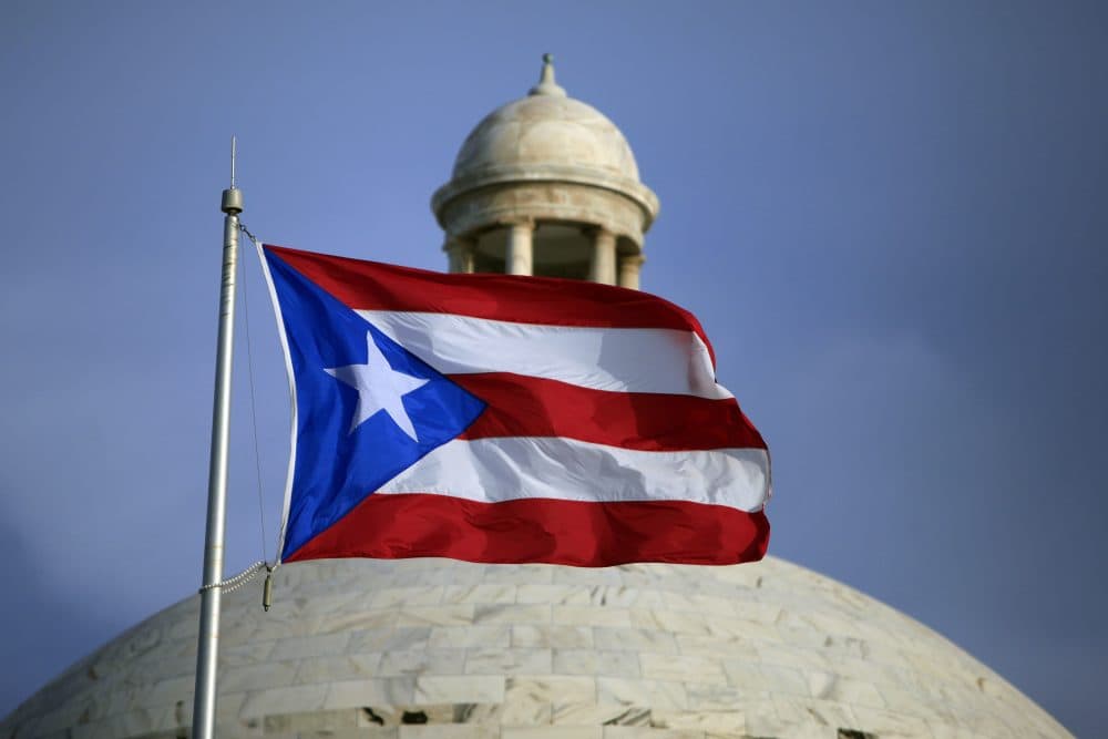 The Puerto Rican flag flies in front of Puerto Rico's Capitol as in San Juan, Puerto Rico, in July 2015 (Ricardo Arduengo/AP)