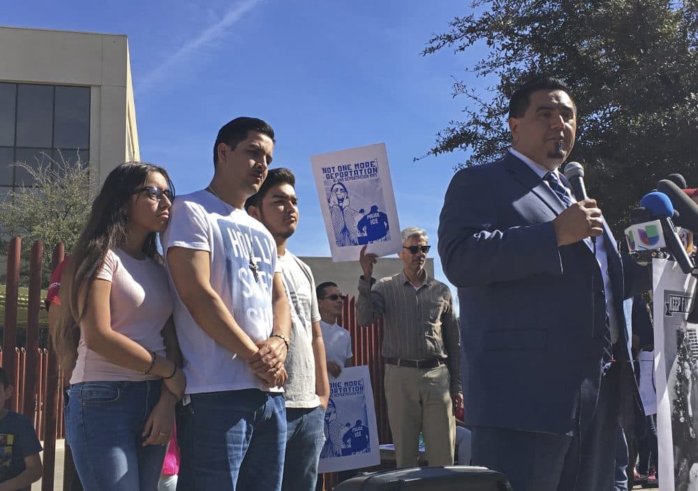 In this Thursday Feb. 9, 2017, photo, the family of Guadalupe Garcia de Rayos stands behind her attorney, Ray Ybarra Maldonado, as he speaks in front of the U.S. Immigration and Customs Enforcement office in Phoenix. (Astrid Galvan/AP)