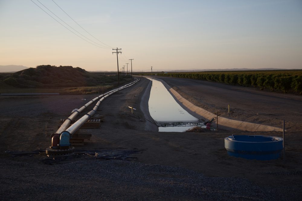 A still image from the documentary &quot;Water and Power,&quot; showing a pipeline allegedly owned by Stewart Resnick, bringing water from Dudley Ridge to Lost Hills. (Courtesy Ted Gesing/National Geographic)