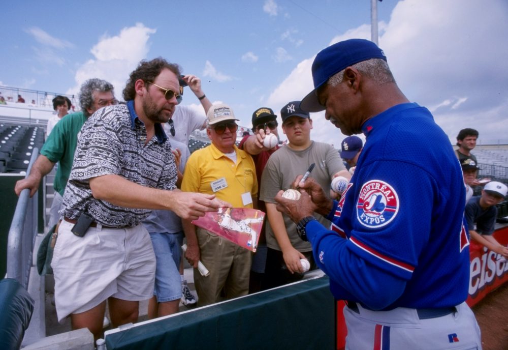 Former Expos manager Felipe Alou signs autographs during spring training in 1998. (Matthew Stockman/Getty Images)