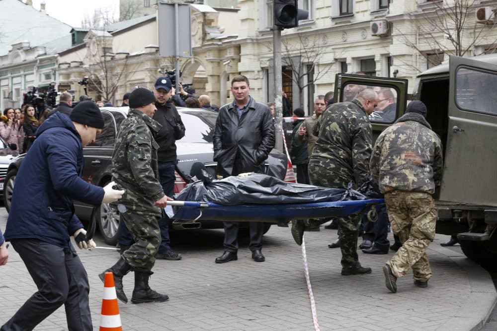 Forensic experts carry the body of Denis Voronenkov, after he was shot dead in Kiev, Ukraine, Thursday, March 23, 2017. (Sergei Chuzavkov/AP)