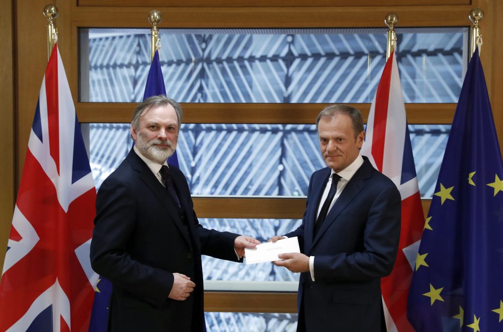 Britain's permanent representative to the European Union Tim Barrow, left, hands British Prime Minister Theresa May's Brexit letter in notice of the UK's intention to leave the bloc under Article 50 to EU Council President Donald Tusk on March 29, 2017. (Yves Herman/Pool Photo via AP)