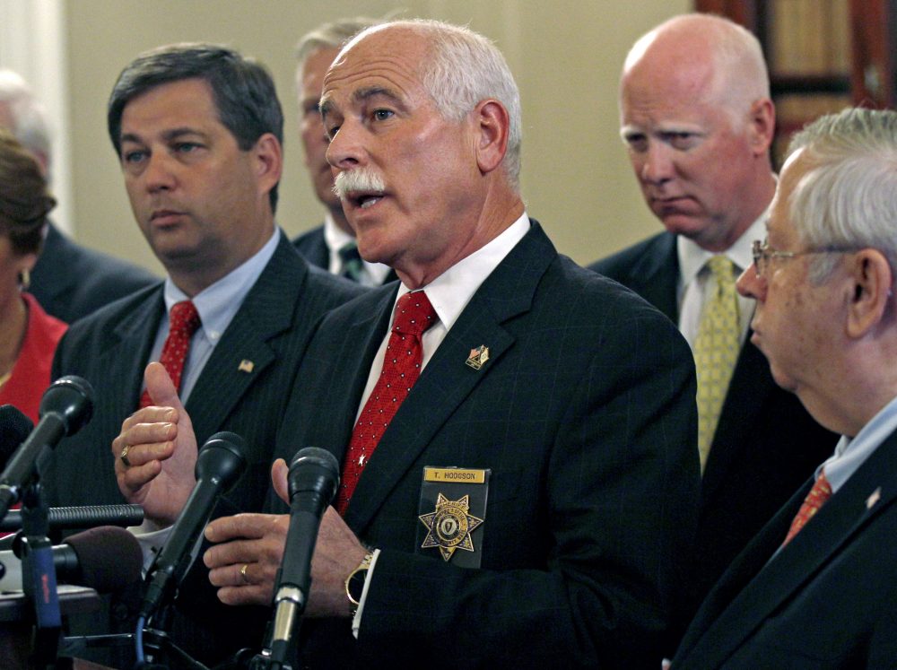 Bristol County Sheriff Thomas Hodgson gestures during a news conference in regard to the &quot;Secure Communities&quot; program, or &quot;S Comm&quot;, held by Massachusetts county sheriffs at the Statehouse in Boston, Wednesday, Sept. 28, 2011. The program is designed to immediately check the immigration status of those arrested for crimes. Opponents say it will lead to profiling.(AP Photo/Charles Krupa)