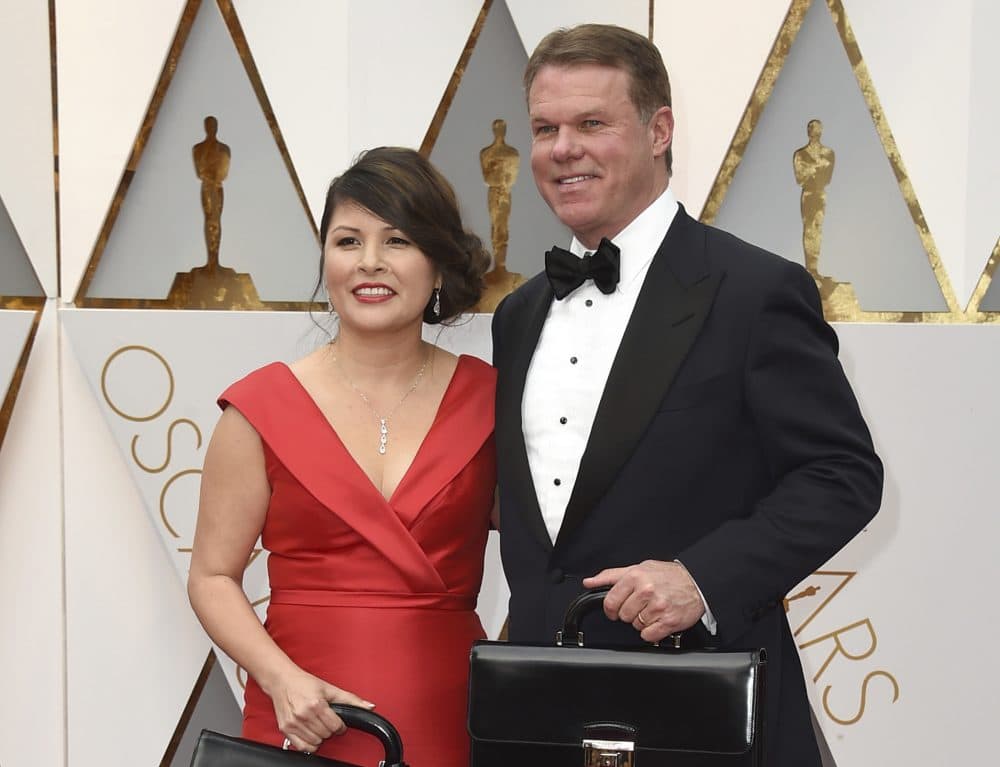 The burning question of the week, writes Tom Keane: If Oscars’ accounting firm Price Waterhouse Coopers had been responsible for counting the votes on Election Night, would Hillary Clinton now be president? Pictured: Martha L. Ruiz, left, and Brian Cullinan from PricewaterhouseCoopers at the Oscars in Los Angeles. Film academy president Cheryl Boone Isaacs says the two accountants responsible for the best picture mistake will not work the Oscars again.  (Jordan Strauss/Invision/AP)