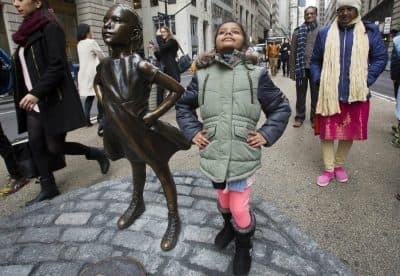 Twice as many girls were taught to be nice and respectful, writes Deborah Pine, as those taught to be leaders. Pictured: Shriya Gupta of Cherokee, N.C. strikes a pose with a statue titled &quot;Fearless Girl,&quot; Wednesday, March 8, 2017, in New York. The statue was installed by an investment firm in honor of International Women's Day. (Mark Lennihan/AP)