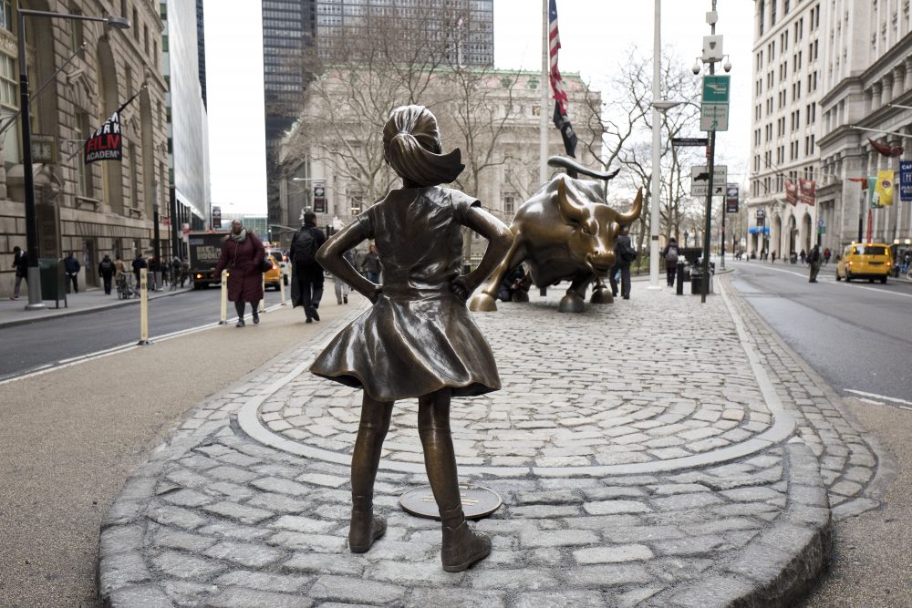 The &quot;Fearless Girl&quot; statue faces Wall Street's charging bull statue in New York City. (Mark Lennihan/AP/file)