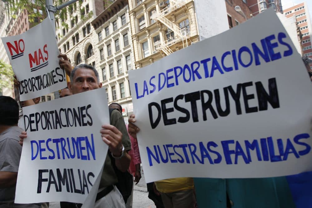 In this July 15, 2011 photo, demonstrators hold signs in New York during a rally to condemn an immigration and customs enforcement program known as Secure Communities. (Mary Altaffer/AP)