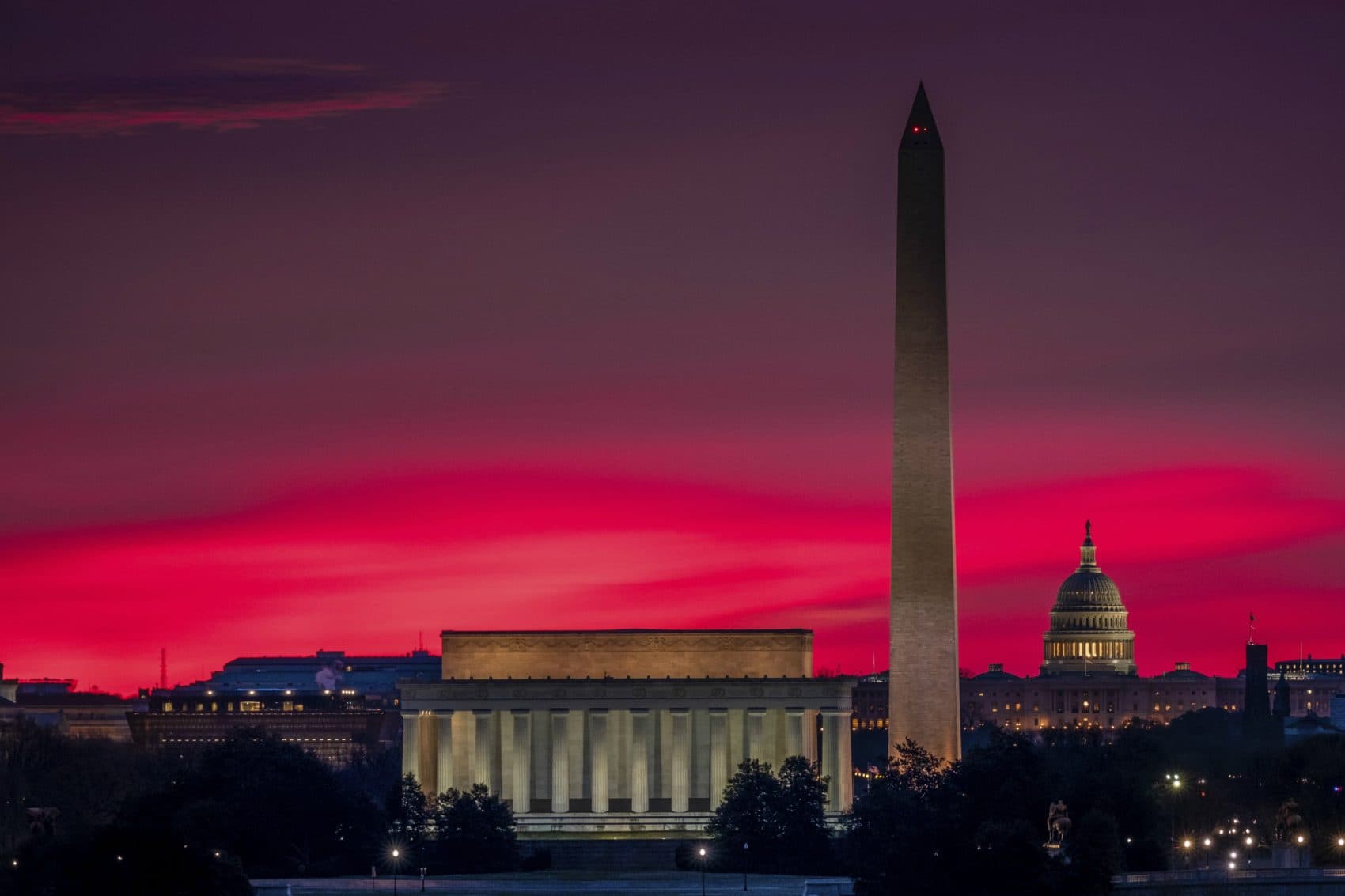 Sunrise behind the skyline of Washington turns the sky red on the first day of daylight saving time in the U.S., Sunday, March 12, 1016. (J. David Ake/AP)