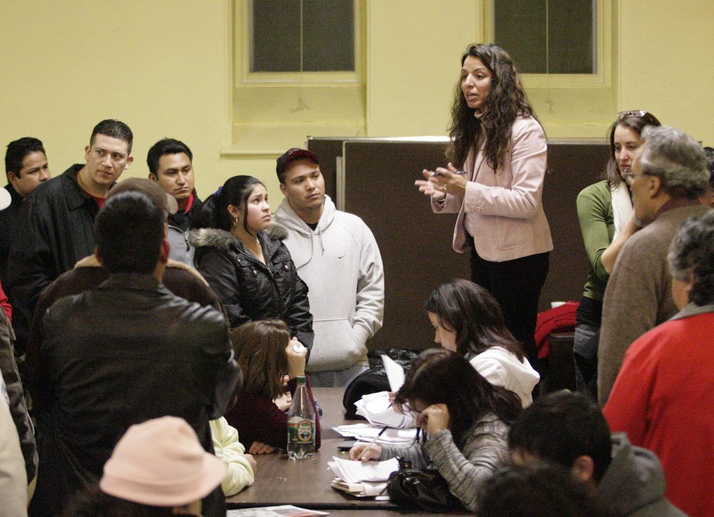 Immigration attorney from Catholic Social services Ondine Galvez-Sniffin, talks to family members and relatives of the 300 immigrants arrested in a federal immigration raid at the Michael Bianco, Inc. factory, Thursday, March 8, 2007, at St. James Church in New Bedford, Mass. (Stew Milne/AP)