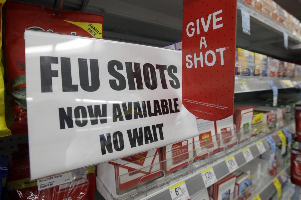 In this file photo, a sign telling customers that they can get a flu shot in a Walgreen store is seen in Indianapolis. (Darron Cummings/AP)