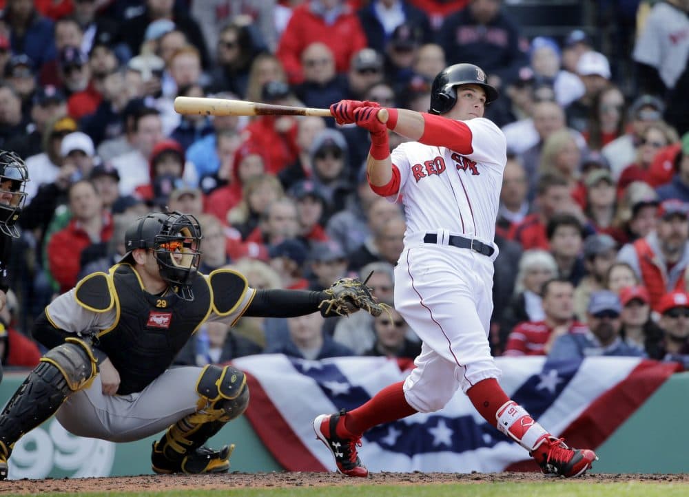 The Boston Red Sox's Andrew Benintendi hits a three-run homer in front of Pittsburgh Pirates catcher Francisco Cervelli during the fifth inning at Fenway Park Monday. (Elise Amendola/AP)