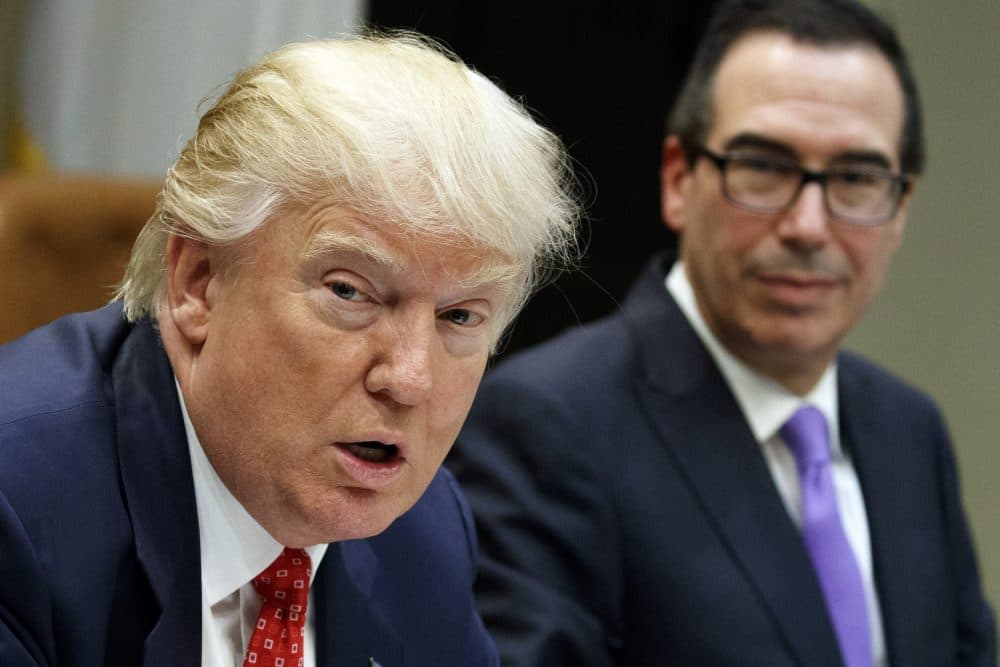 Treasury Secretary Steven Mnuchin listens as President Trump speaks during a meeting on the Federal budget at the White House in February 2017. (Evan Vucci/AP)