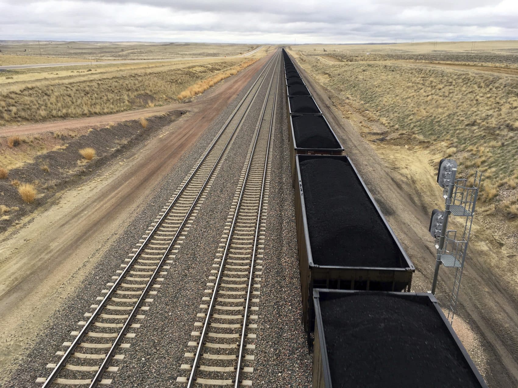 A train near hauls coal mined from Wyoming's Powder River Basin near Bill, Wyo., Tuesday, March 28, 2017. President Donald Trump's lifting of a federal coal leasing moratorium issued last year by President Barack Obama will allow new leasing of federal coal to resume in the basin and elsewhere. (Mead Gruver/AP)