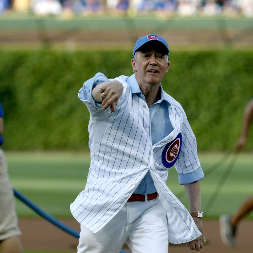 NPR's Scott Simon, a lifelong Cubs fan, throws out the first pitch before a game in 2016. Later that year, the Cubs won their first World Series in 108 years. (Matt Marton/AP)