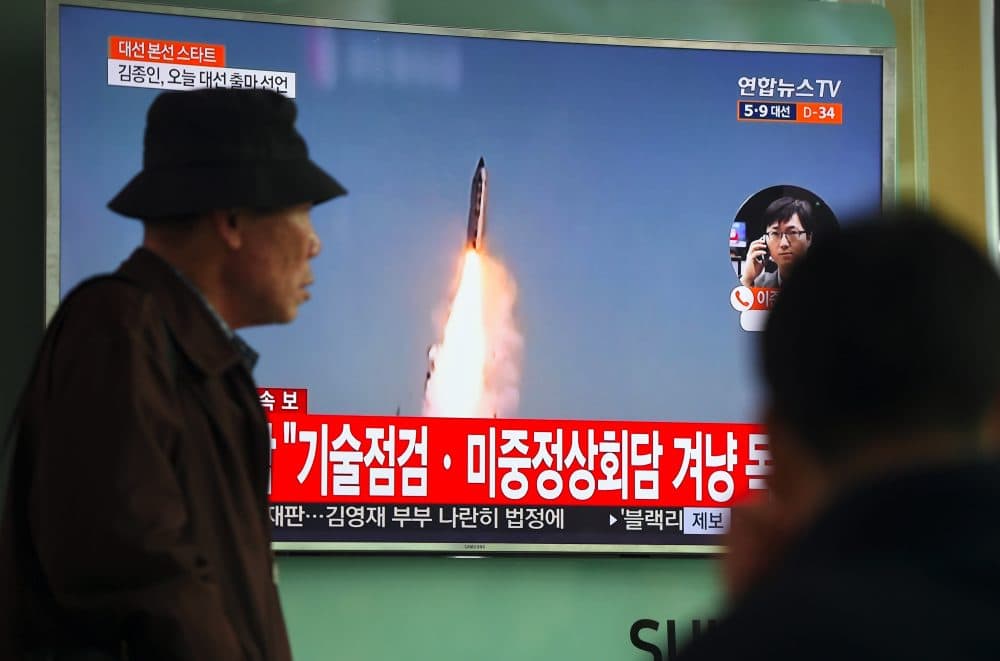 A man walks past a television screen showing file footage of a North Korean missile launch, at a railway station in Seoul on April 5, 2017. (Jung Yeon-Je/AFP/Getty Images)