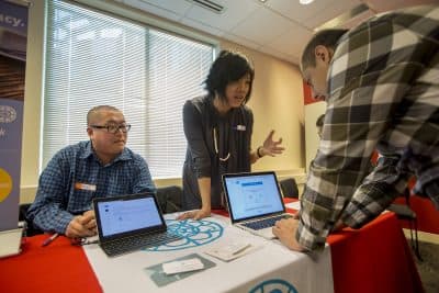 Dr. Mark Zhang and MIT engineer Suelin Chen present their app Cake at the Digital Health Innovation Showcase at Harvard Pilgrim Health Care in Wellesley. (Jesse Costa/WBUR)