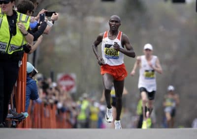 Geoffrey Kirui, of Kenya, leads Galen Rupp, of the U.S., and the rest of the field along the course of the 121st Boston Marathon on Monday in Brookline, Mass. (Steven Senne/AP)