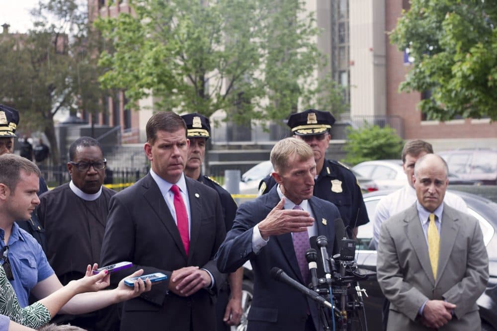In this file photo, Boston Police Commissioner William Evans addresses reporters with Boston Mayor Marty Walsh after a fatal shooting in Dorchester in June of 2016. The city will be deploying &quot;trauma teams&quot; to certain neighborhoods to help connect people with mental health resources following violent incidents. (Joe DiFazio for WBUR)