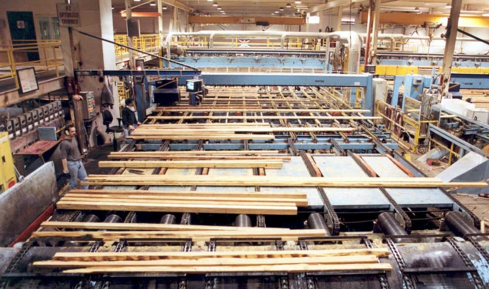 Workers prepare lumber inside Weyerhaeuser's Port Alberni Mill on Vancouver Island in British Columbia. (Weyerhauser Company/AP)