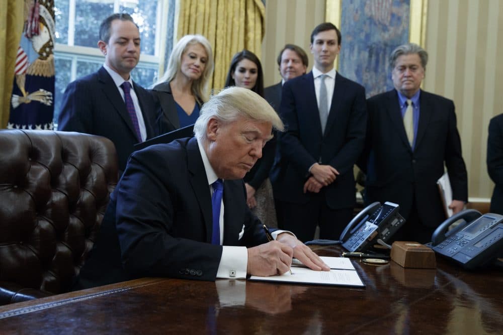 President Trump signs an executive order on the Keystone XL pipeline, Tuesday, Jan. 24, 2017, in the Oval Office of the White House in Washington. (Evan Vucci/AP)