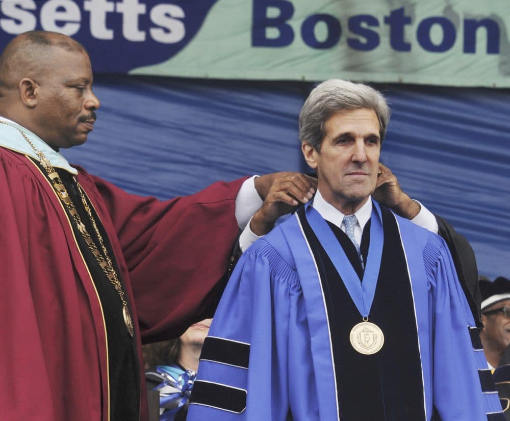 Then-Sen. John Kerry receives the Chancellor's Medal as University of Massachusetts Boston Chancellor J. Keith Motley stands at left during UMass Boston commencement on May 29, 2009. (Lisa Poole/AP)