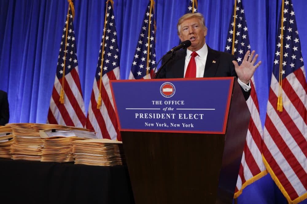 Then-President-elect Donald Trump speaks during a Jan. 11 news conference next to a stack of folders that he said contained documentation separating him from his businesses. (Evan Vucci/AP)