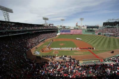 The Boston Children's Chorus performs the national anthem behind second base as the Pittsburgh Pirates, left, and Boston Red Sox stand along the baselines before their opening day baseball game at Fenway Park, on Monday. (AP/Steven Senne)