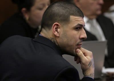 Former New England Patriots tight end Aaron Hernandez is seated during closing arguments in his double murder trial at Suffolk Superior Court Thursday. (Steven Senne/AP)