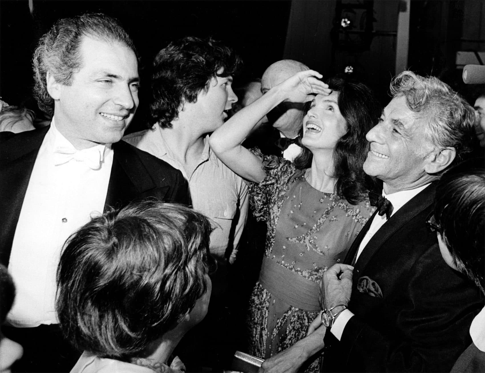 Jacqueline Kennedy Onassis shields the light from her eyes as she looks up at the stage in the John F. Kennedy Center for the Performing Arts on June 5, 1972, in Washington. With her is conductor-composer Leonard Bernstein who wrote &quot;Mass&quot; for the opening of the cultural center. (AP)