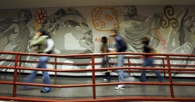 Trump's proposed budget will take nearly $100 million away from thousands of Massachusetts students who cannot afford to go to college without that help, writes Richard Doherty. Pictured here: English High School students walk past a mural at the school in Jamaica Plain. (Elise Amendola/AP)