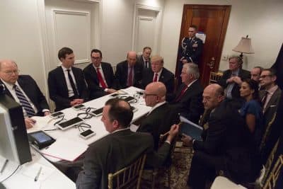 In this image provided by the White House, President Donald Trump receives a briefing on the Syria military strike from his National Security team after the strike at Mar-a-Lago in Palm Beach, Fla. (White House via AP)