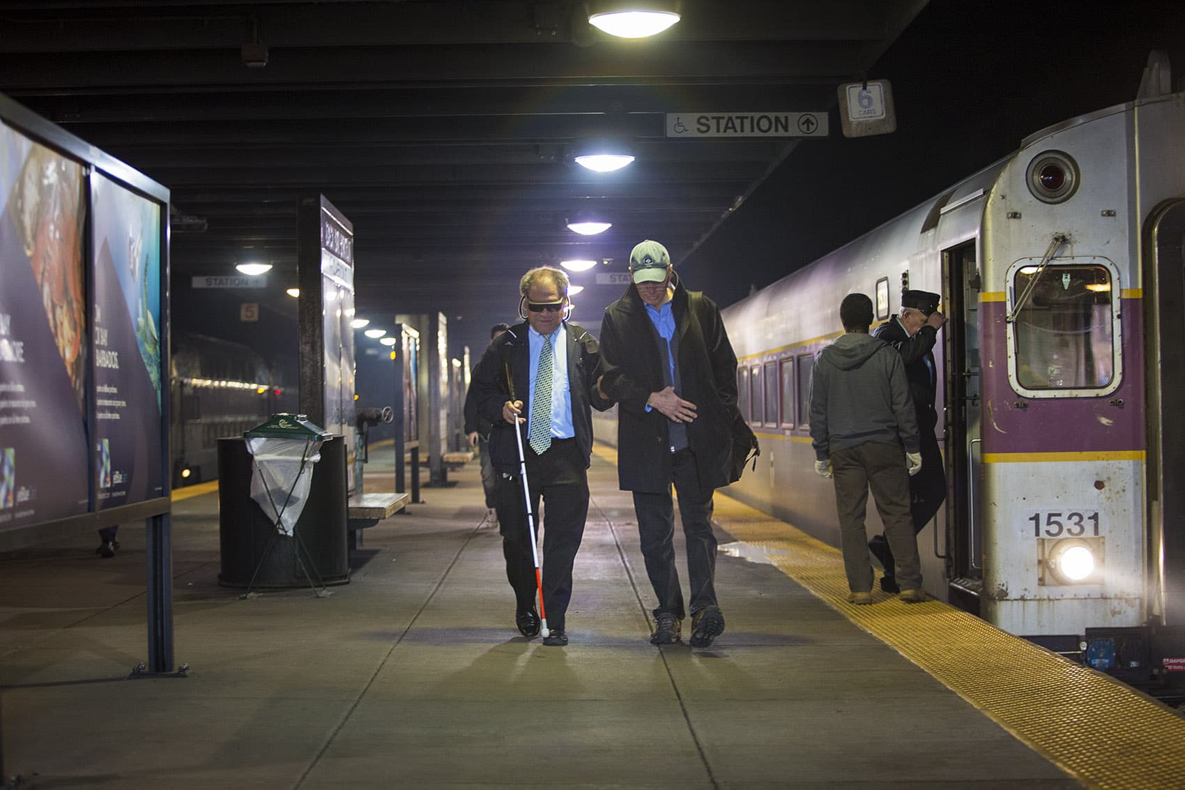 Whenever they're on the same commuter rail train, David Hill, right, meets Blair Wong on the platform at Back Bay station and walks him to Benjamin Franklin Institute of Technology. (Jesse Costa/WBUR)