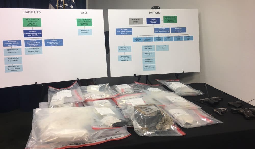 At a press conference Tuesday at the Moakley Courthouse, federal authorities displayed suspected fentanyl and guns they seized in an early-morning sweep of an alleged drug trafficking operation based in Lawrence. [Photo: Katie Lannan/SHNS]