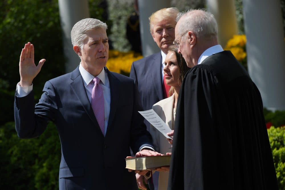 President Trump (second from left) watches as Justice Anthony Kennedy (right) administers the oath of office to Neil Gorsuch as an associate justice of the U.S. Supreme Court in the Rose Garden of the White House on April 10, 2017, in Washington, D.C., as Gorsuch's wife, Louise Gorsuch, looks on. (Mandel Ngan/AFP/Getty Images)