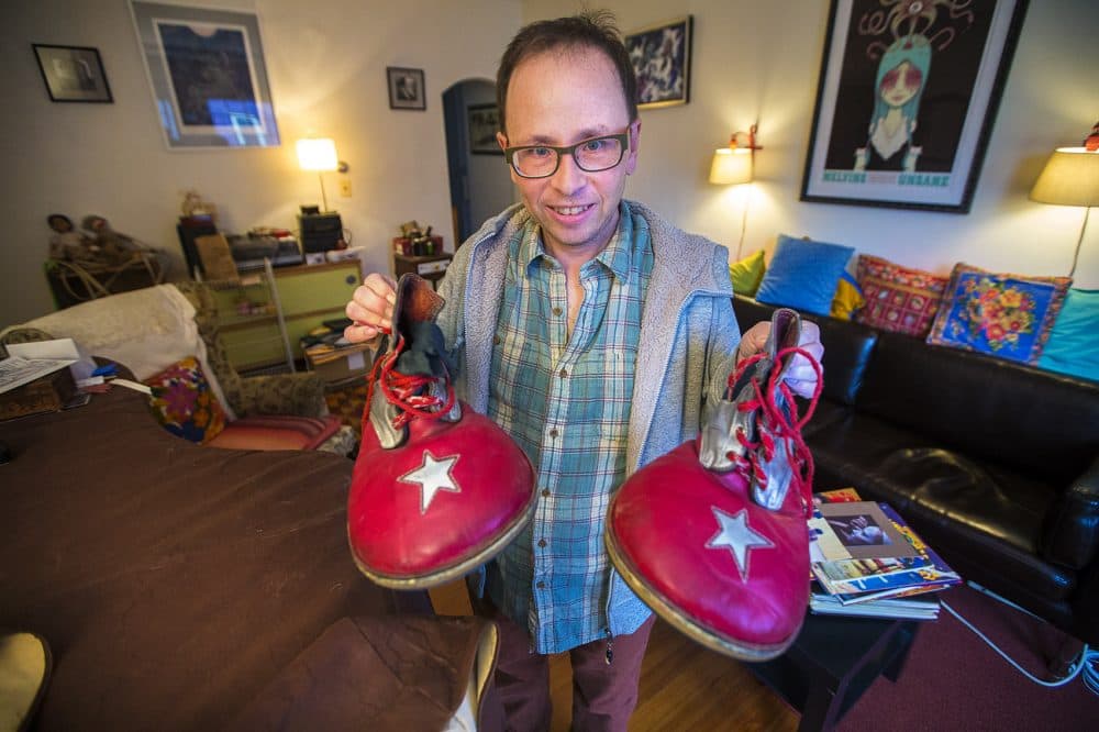 Peter Bufano holds the clown shoes he wore during his tenure as a clown with the Ringling Bros. and Barnum & Bailey Circus. (Jesse Costa/WBUR)