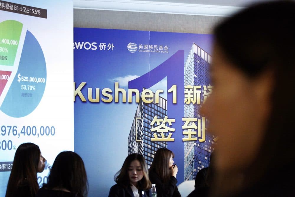 Chinese staff wait for investors at a reception desk during an event promoting EB-5 investment in a Kushner Companies development at a hotel in Shanghai, China, Sunday, May 7, 2017. (AP)