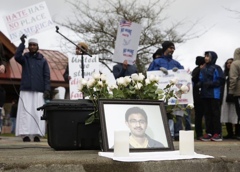 A photo of Srinivas Kuchibhotla, the 32-year-old Indian engineer killed at a bar in Olathe, Kansas, is pictured during a peace vigil in Bellevue, Wash., on March 5, 2017. (Jason Redmond/AFP/Getty Images)