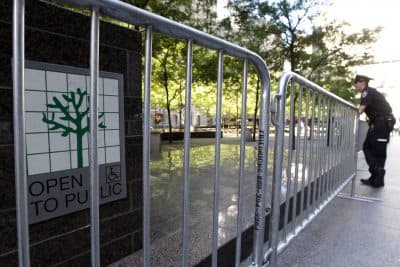 A police officer stands guard outside metal barricades surrounding Zuccotti Park, Saturday, Sept. 15, 2012, in New York, during Occupy Wall Street protests. The park is a privately-owned public space. (Mary Altaffer/AP)