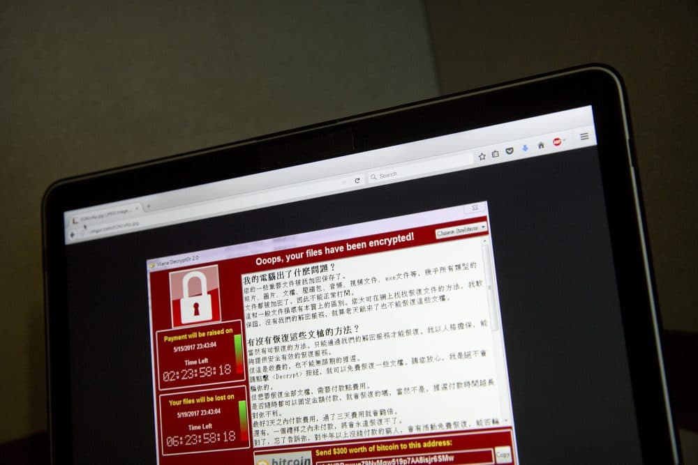 In this May 13, 2017 file photo, a screenshot of the warning screen from a purported ransomware attack, as captured by a computer user in Taiwan, is seen on laptop in Beijing. (Mark Schiefelbein/AP)
