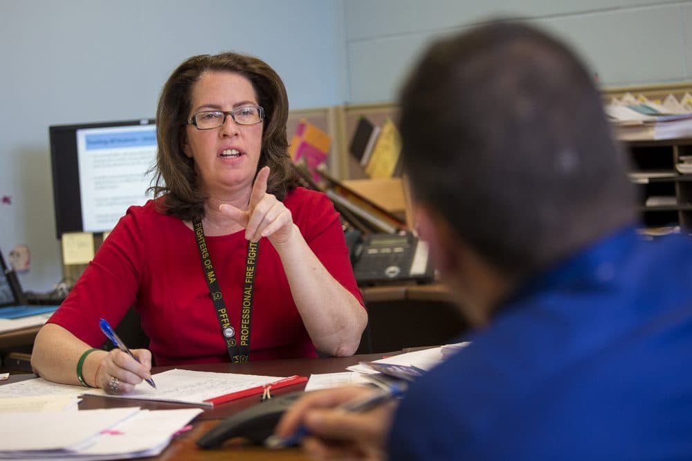 Superintendent of Revere Schools Dianne Kelly speaks with Assistant Superintendent Josh Vadala about their presentation of this year's goals to the school committee. (Jesse Costa/WBUR)