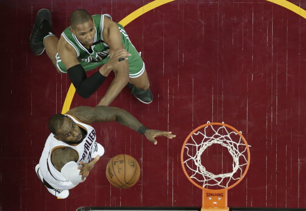 Cleveland Cavaliers' LeBron James, left, drives to the basket against Boston Celtics' Al Horford, from Dominican Republic, in the second half of Game 4 of the NBA basketball Eastern Conference finals on Tuesday in Cleveland. (Tony Dejak/AP)