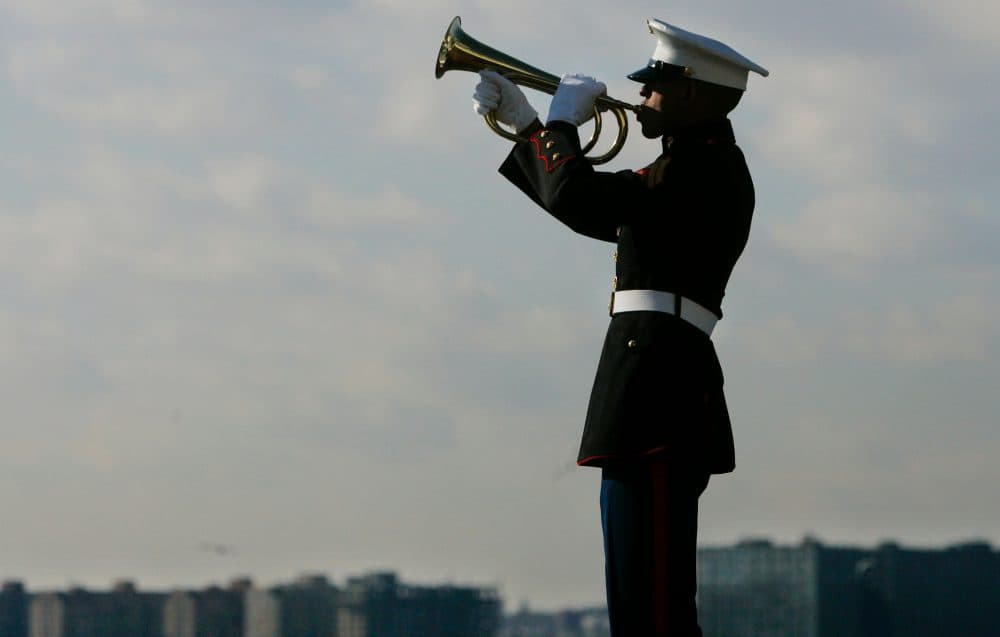 A U.S. Marine Corps bugler plays taps during a ceremony on the USS Intrepid Air and Space Museum in New York City. (Stephen Chernin/Getty Images)