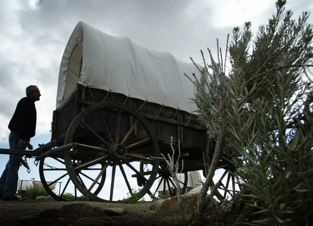 Loren Case, of Boise, Idaho., looks at a life-size wagon replica at the Oregon Trail Interpretive Center located on the Oregon Trail, June 11, 2004, near Baker City, Ore. (Rick Bowmer/AP)