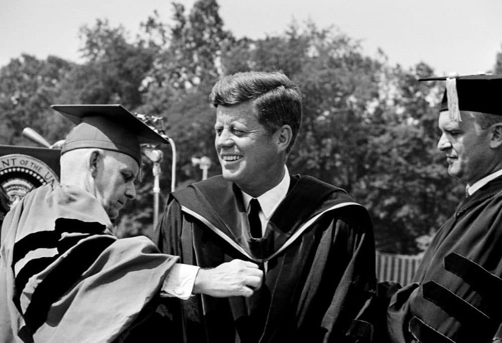 President John Kennedy wears academic robe and hood after receiving the honorary degree of doctor of laws from American University at graduation exercises in Washington June 10, 1963. (AP)